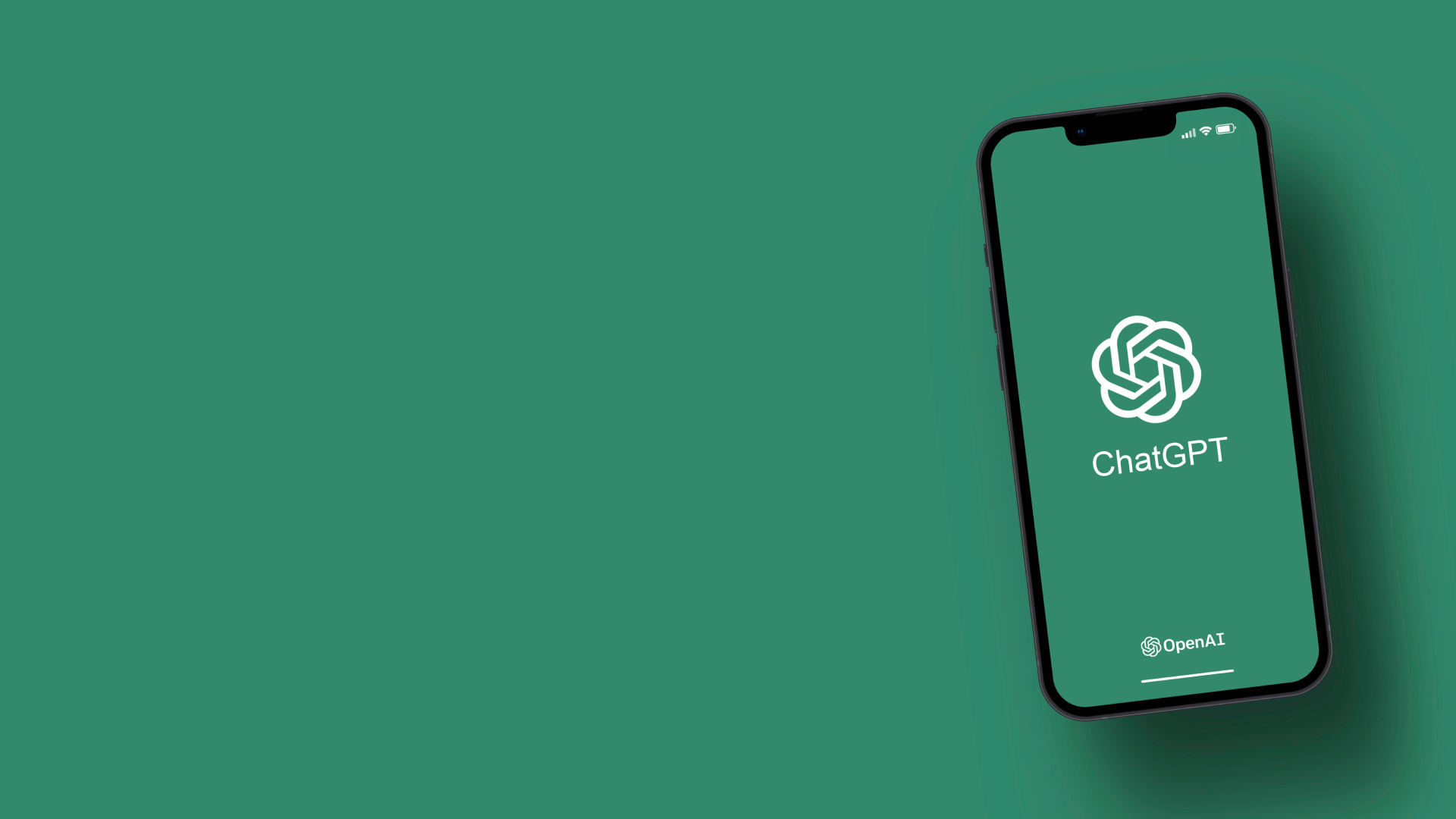 The image shows an iPhone displaying the ChatGPT app's loading or splash screen against a green background. The screen features ChatGPT's white logo (which appears as an abstract, circular knot-like design) at the center, with "ChatGPT" text below it, and "OpenAI" branding at the bottom. The iPhone appears to be floating or tilted at an angle, and the background is a solid emerald or forest green color that creates a minimalist, professional appearance. The device appears to be a recent iPhone model with a notch at the top of the display.